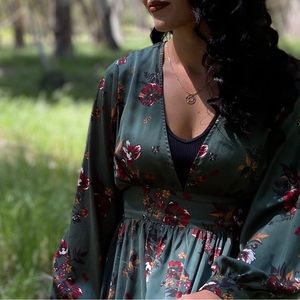 Emerald low cut long sleeve dress. Flattering to the waist, and flowy.